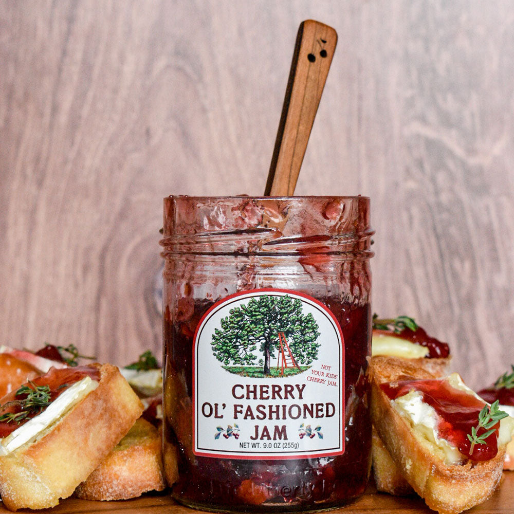 A jar of Cherry Republic cherry jam surrounded by toasts