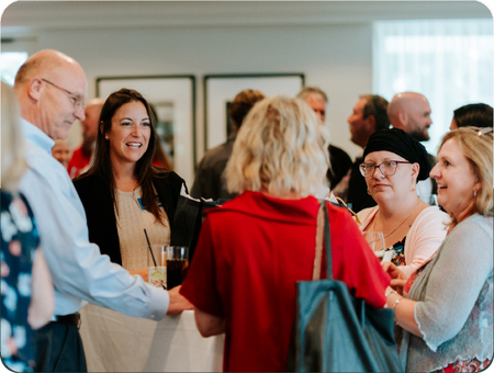 Guests talking and shaking hands at a Cherry Republic corporate reception