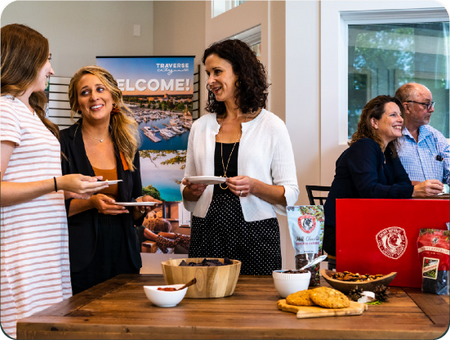 Colleagues sharing Cherry Republic snacks around a tasting table